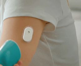 Person applying a SIBIONICS continuous glucose monitor